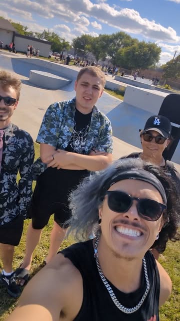 Outdoor group selfie at a skatepark.